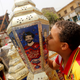 An Egyptian boy kisses the traditional decorative lanterns known as "Fanous" bearing the image of Liverpool's Egyptian forward soccer player Mohamed Salah, at a market, before the beginning of the holy fasting month of Ramadan in Cairo, Egypt May 2, 2018. Arabic words read "Ramadan is sweeter with Salah".
